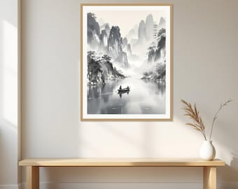 May include: A framed wall art print featuring a black and white ink wash landscape painting of jagged mountains, misty valleys, and a small boat with a person rowing on a calm body of water, presented in a light wood frame on a plain wall.