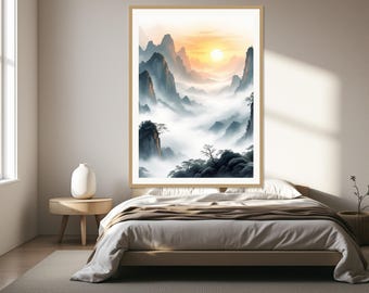 May include: A framed vertical wall art print depicting a mountain landscape with jagged peaks, dense fog, and a bright sun glowing in a soft orange sky. The artwork features dark silhouettes of trees in the foreground and misty valleys below.