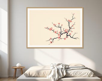 May include: A rectangular wall art print featuring a dark brown branch with light pink cherry blossoms against a solid cream background, enclosed in a light wood frame. The artwork is displayed horizontally on a plain wall above a low bed.