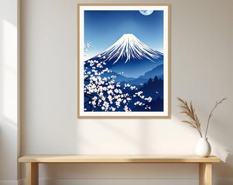May include: A framed wall art print featuring a stylized landscape of a snow-capped mountain peak under a dark blue night sky with a crescent moon. In the foreground, a dark tree branch is covered in white cherry blossoms against the blue scene.
