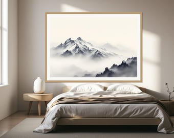May include: A framed landscape wall art print featuring a mountain range with snow-capped peaks partially obscured by thick, low-hanging clouds. The artwork uses a monochromatic palette of white, gray, and black tones, presented in a light wood frame.