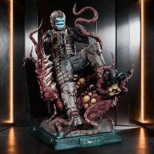 May include: A detailed collectible figurine of a futuristic armoured character wearing a helmet with glowing blue horizontal visor lights, holding a mechanical tool, and surrounded by dark red, fleshy, tentacled organic growths on a base.