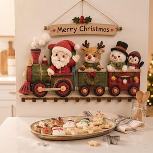May include: A wall-hanging crochet train decoration featuring Santa Claus in the engine, a reindeer, a snowman, and a penguin in the cars. A wooden sign above reads Merry Christmas with holly. Below, a platter holds various holiday-shaped cookies.