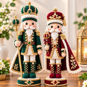May include: Two crocheted nutcracker dolls standing on circular bases. The left doll wears a green uniform with gold trim, pearls, and a crown, holding a staff. The right doll wears a red uniform with gold trim, pearls, and a crown, holding a scepter.