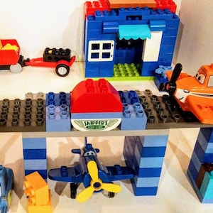 Large Lego Duplo Set Skippers Flying School, Road Repair Equipment, Fire House, Truck, and a Home. Hours of play and learning skills.