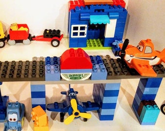 Large Lego Duplo Set Skippers Flying School, Road Repair Equipment, Fire House, Truck, and a Home. Hours of play and learning skills.