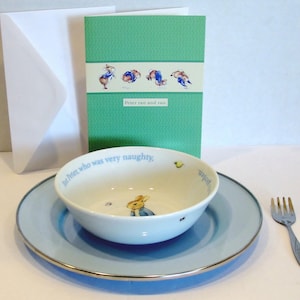 Peter Rabbit Breakfast Place Setting that includes a Bowl, Plate, Fork and Card