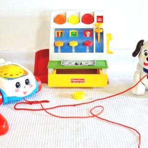 Fisher Price Pull Toy Dog, Pull Toy Phone, and a Cash Register with Coins