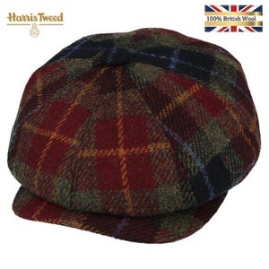 May include: A newsboy cap crafted from Harris Tweed wool featuring a multi-colored plaid pattern in shades of deep red, forest green, and black with thin yellow and blue overcheck lines. The cap includes a small button at the top center.