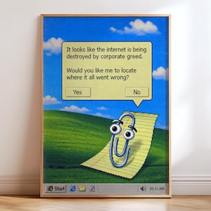 May include: A framed wall print featuring a digital illustration of a paperclip character on a green hill background. A yellow speech bubble contains the text: It looks like the internet is being destroyed by corporate greed. Would you like me to locate where it all went wrong? with Yes and No buttons.