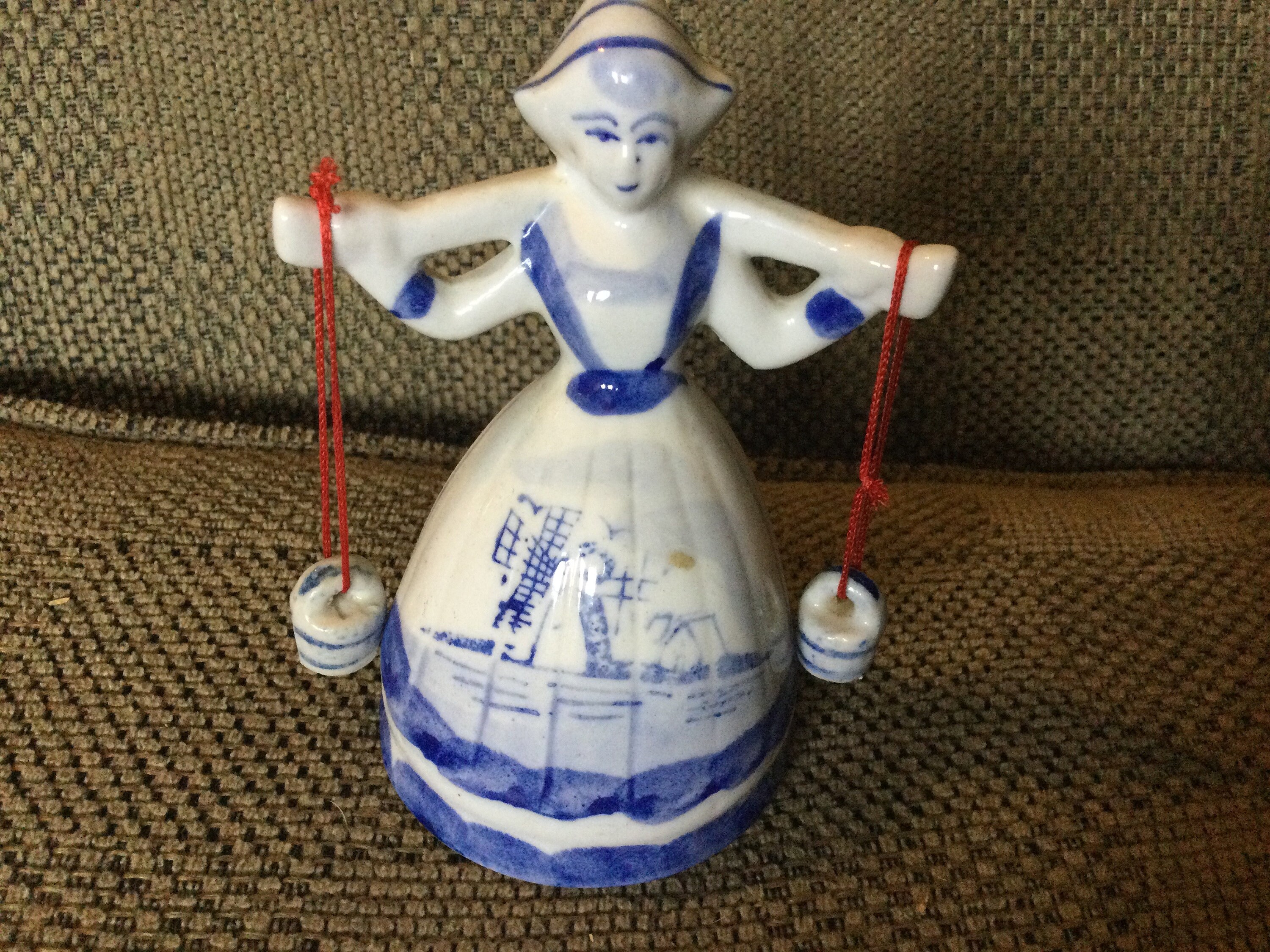 Vintage Dutch Girl hauling two buckets of water ( on strings).