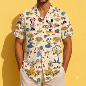 May include: A short-sleeve button-down shirt in a light cream color featuring an all-over print of Disney characters including Mickey Mouse, Minnie Mouse, Donald Duck, Daisy Duck, Goofy, and Pluto, alongside various food items, flags, and globes.