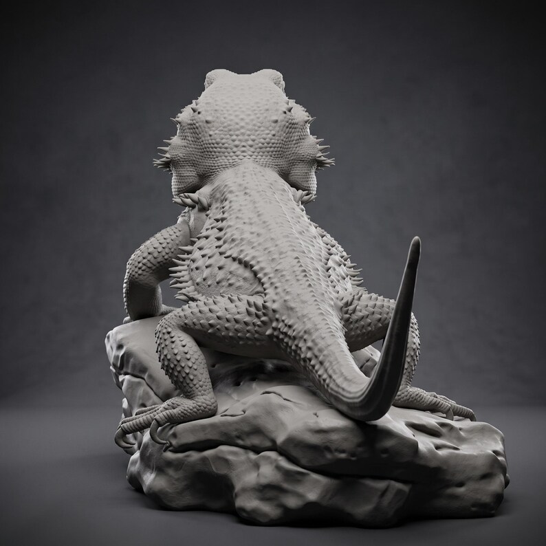 High-detail 3D printed miniature of a Bearded Dragon (Pogona) captured in a natural basking pose on a textured rock, showing intricate scale patterns from a low-angle perspective. Printed in grey using Anycubic Standard Resin V2 at 14K resolution. Ideal for painters and collectors. 🐉🦎 #3dprinting #beardeddragon #minipainting