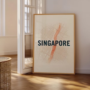 May include: A rectangular framed wall art print featuring a stylised map of Singapore. The design includes a central vertical orange waterway surrounded by a grid of grey streets on a cream background, with the word SINGAPORE in dark blue text.