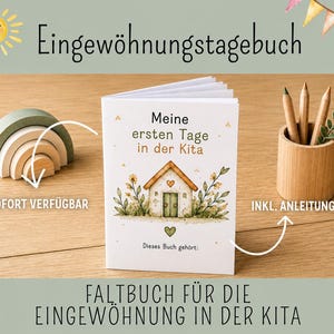 Könnte beinhalten: Ein weißes Heft mit dem Titel Meine ersten Tage in der Kita und einer Aquarellillustration eines Hauses, Blumen und Herzen. Daneben stehen ein hölzerner Regenbogen-Stapler und ein zylindrischer Stiftehalter aus Holz mit drei Stiften.