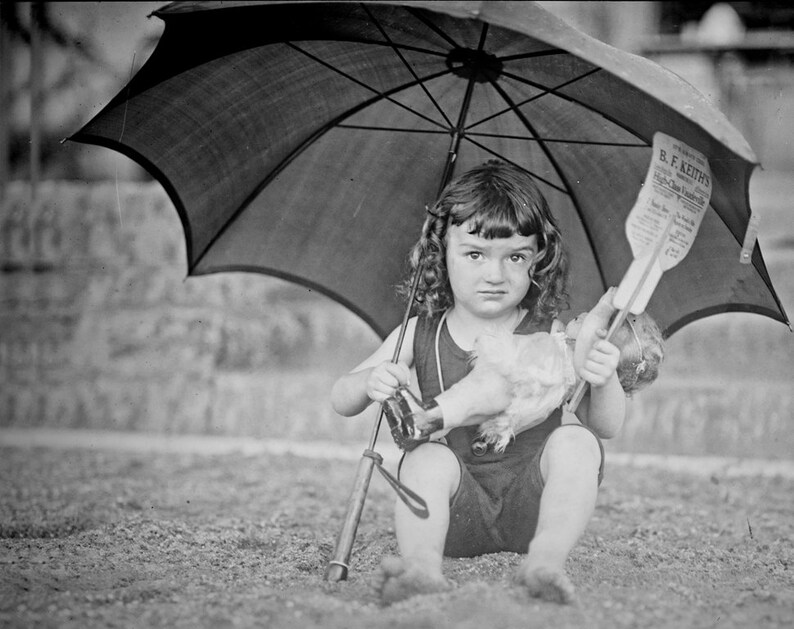 1923 Vintage Image of Girl on Beach Holding Umbrella and Doll, 10x8 image 1