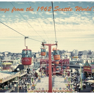 May include: Vintage postcard image of the 1962 Seattle World's Fair, featuring a red and orange aerial tramway with gondolas. The image includes the text "Greetings from the 1962 Seattle World's Fair" in orange. The fair is set against a backdrop of a city skyline.