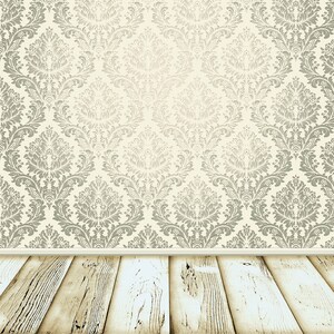 May include: A vintage-style room with a white wood floor and a wall covered in a beige and silver damask wallpaper.