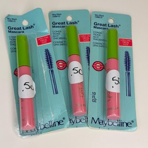 May include: Three Maybelline Great Lash mascara tubes in special trial size packaging. Each tube has a bright green cap and a pink body, attached to a light blue cardboard backing. The text reads Very Black, Great Lash Mascara, and .10 FL OZ.