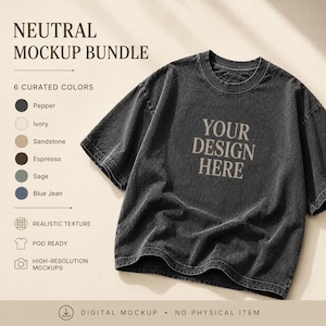 Può includere: Una t-shirt a maniche corte grigio antracite con effetto lavaggio vintage, che riporta il testo YOUR DESIGN HERE in un carattere serif. L'immagine include un elenco di sei opzioni di colore: Pepper, Ivory, Sandstone, Espresso, Sage e Blue Jean.