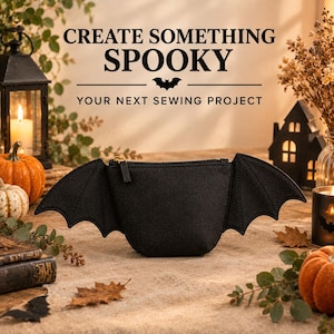 May include: A black fabric pouch shaped like a bat with extended wings on both sides and a gold zip closure. The text CREATE SOMETHING SPOOKY YOUR NEXT SEWING PROJECT is displayed above the pouch in a black serif font with a small bat icon.