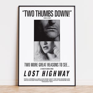 May include: A black and white film poster for Lost Highway, directed by David Lynch. The design features a split-face image of a man and a woman, with the text "TWO THUMBS DOWN!" at the top and "TWO MORE GREAT REASONS TO SEE..." above the title.