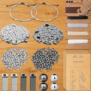 May include: A jewelry making kit featuring two finished bracelets, piles of silver and dark gray rectangular beads, round metallic beads, four rectangular metal bars, four large round beads, spools of colored cord, and Morse code cards.