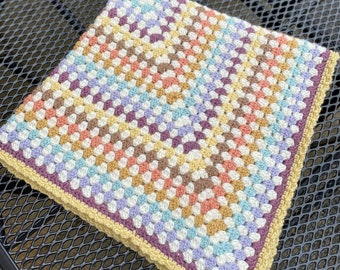 Beautiful granny square baby blanket in retro colours suitable for a stroller or pushchair