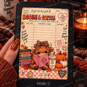 May include: A black e-reader displaying a digital library card graphic featuring a fluffy highland cow reading a pink book titled Just One More Chapter, surrounded by pumpkins, coffee, and autumn-themed text like Books & Coffee and Fall Readers Club.