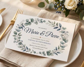 May include: A rectangular wedding invitation card featuring a watercolor eucalyptus wreath in shades of green and blue. The text reads Marie & Pierre, 30 septembre 2026 à 15h00, Château de Fontainebleau, 15 Rue de la Paix, 75002 Paris, and contact details.