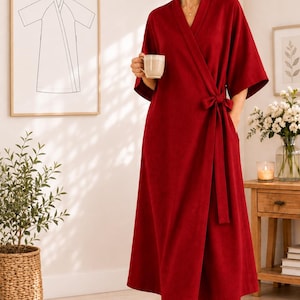 May include: A deep red wrap-style robe featuring a V-neckline, three-quarter length sleeves, and a matching fabric tie belt at the waist. The garment has a midi-length hemline and a clean, solid-colored design with a simple, structured silhouette.