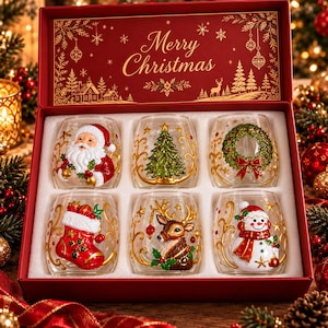 May include: A set of six clear glass tumblers in a red gift box labeled Merry Christmas. Each glass features a raised, hand-painted holiday design: a Santa Claus, a Christmas tree, a wreath, a stocking, a reindeer, and a snowman.