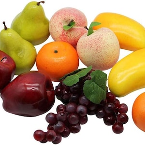 May include: A collection of artificial fruit including two dark red apples, two light green pears, two bright orange tangerines, two yellow mangoes, two speckled peaches, and a cluster of dark purple grapes with green leaves on a white background.