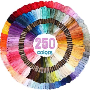 May include: A circular arrangement of 250 embroidery floss skeins in a wide spectrum of colors, including reds, blues, greens, yellows, and purples. Each skein features a black paper label. The text 250 colors is centered in the middle.