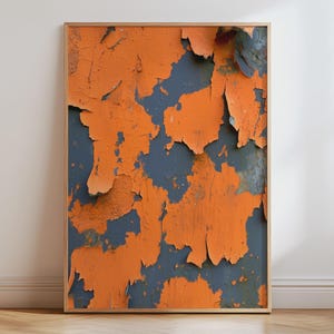 May include: A rectangular wall art print in a thin wooden frame featuring a high-contrast abstract pattern of bright orange paint peeling away to reveal a dark charcoal grey surface underneath, creating a textured and layered visual effect.