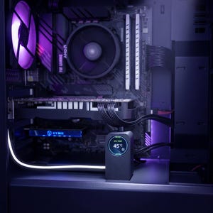 May include: A black computer case interior featuring a motherboard with an AMD processor cooler, a graphics card, and a black GPU support bracket with a circular LCD screen displaying 45 degrees Celsius. A purple illuminated fan and white LED strip.