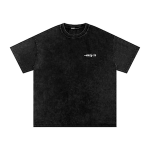 May include: A black acid-wash short-sleeve t-shirt with a crew neckline. The shirt features the text --ship it in white typewriter-style font on the upper right chest area and a small black brand label inside the collar.