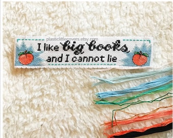 May include: Cross stitch pattern PDF for a bookmark with the text "I like big books and I cannot lie" and two peach illustrations.