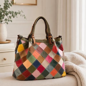 May include: A multi-colored leather handbag featuring a diamond-shaped patchwork pattern in shades of red, yellow, green, blue, pink, and brown. The bag includes two top handles, dark metal hardware, and a structured base with a spacious main compartment.