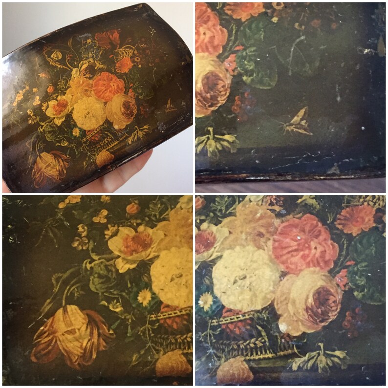 May include: Antique wooden box with a floral design. The box is painted with a dark background and features a bouquet of yellow, pink, and white flowers in a vase. The flowers are surrounded by green leaves and a small butterfly.