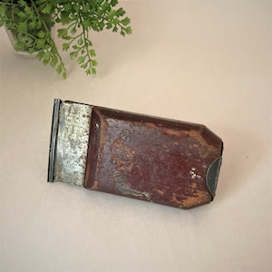 May include: A vintage wooden and metal scraper with a metal blade and a wooden handle. The blade has the text "MADE IN U.S.A.  PAT. PEND.  NO. 455215" printed on it.