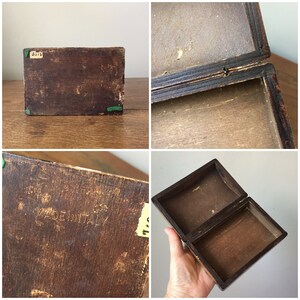 May include: A wooden box with a hinged lid. The box is brown and has a label on the bottom that reads "MADE IN ITALY".