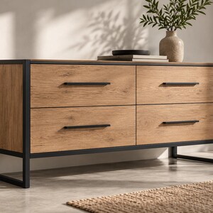 May include: A rectangular four-drawer dresser featuring a light brown wood grain finish and a black metal frame. The dresser has four horizontal black metal drawer pulls and is supported by a black metal base with four legs.