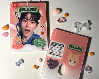 May include: Two rectangular acrylic photo holders with a pink gradient design. One features a portrait of a person, the text JELLIES, and cartoon bear graphics. The other displays a nutrition facts label, the text JELLIES, and a heart icon.