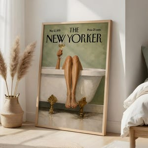 Könnte beinhalten: Ein gerahmter Kunstdruck, der ein Vintage-Cover des Magazins The New Yorker vom 12. Mai 1979 zeigt. Die Illustration zeigt ein Paar Beine, die aus einer weißen Badewanne mit goldenen Füßen ragen, während eine Hand ein Glas Weißwein hält.