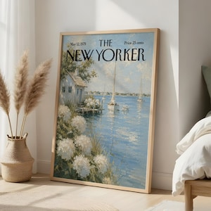 May include: A framed print of The New Yorker magazine cover dated May 12, 1979, featuring an oil painting of a coastal scene with a white cottage, blooming white hydrangeas, and sailboats on blue water under a light blue sky.