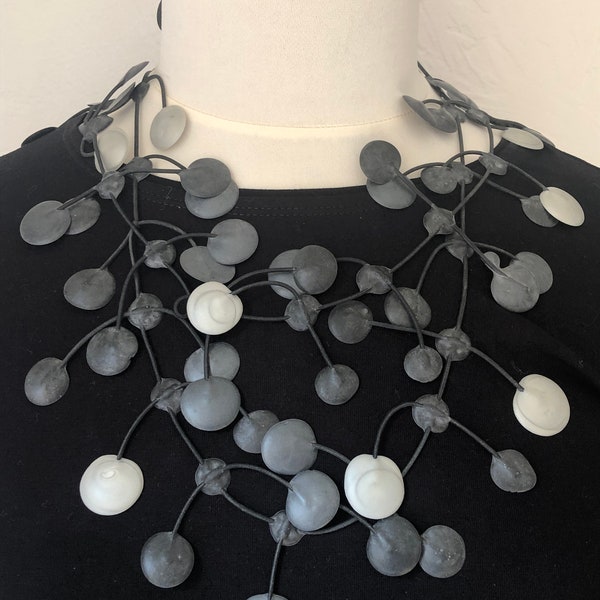 necklace made of latex in the colors black,silver and dark grey.