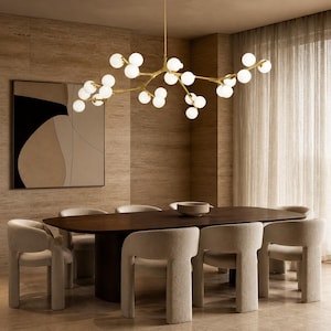 May include: A branching gold chandelier featuring numerous spherical white glass globes suspended from a central rod. The fixture has an organic, tree-like structure with multiple arms extending outward, each ending in a glowing orb light source.