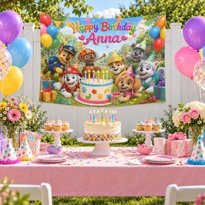 Pode incluir: Um conjunto de festa de aniversário com o tema Patrulha Pata, incluindo um grande pano de fundo com o texto Happy Birthday Anna, um bolo branco com granulado colorido e velas, caixas de presente, chapéus de festa e balões rosa, azuis e amarelos.