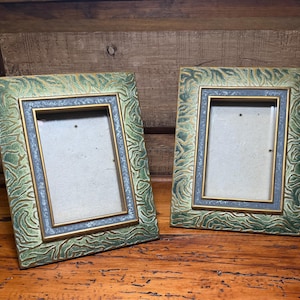 May include: Two rectangular picture frames featuring a textured green and gold marbled pattern on the outer border, a thin gold inner rim, and a dark gray inner border with a subtle speckled finish, designed for displaying vertical photographs.